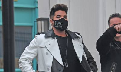 Adam Lambert Masks Up While Stopping By a Theater in London - www.justjared.com - London