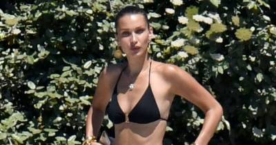 Bella Hadid Shows Offs Her Enviable Figure in a Tiny Black Bikini While on Set in Corsica - www.usmagazine.com - France