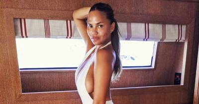 Chrissy Teigen’s Hottest Swim Moments, From the Ed Hardy Runway to a Vacation With John Legend - www.usmagazine.com