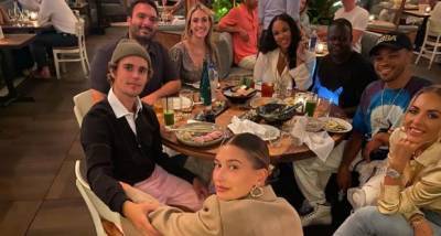 Justin Bieber won't let go of Hailey Baldwin's hand as the lovebirds pose for a photo with the singer's team - www.pinkvilla.com