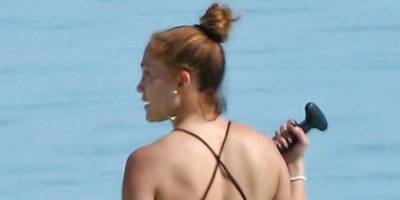Jennifer Lopez Hits the Water in a Sleek Black Strappy Swimsuit - www.harpersbazaar.com