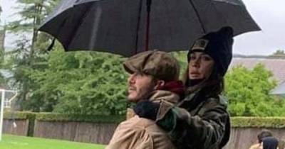 David and Victoria Beckham cuddle up as they attend son Cruz's football match - www.ok.co.uk - Britain