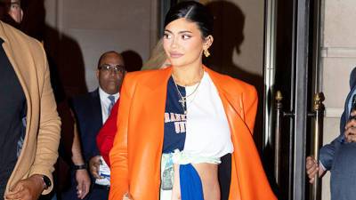 Kylie Jenner Cradles Her Baby Bump Channels Kim Kardashian In All-Red Look — Watch - hollywoodlife.com