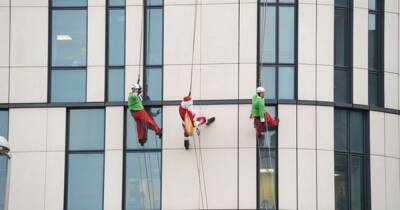 Santa abseils down Scots hospital to bring festive cheer to children spending Christmas there - www.dailyrecord.co.uk - Scotland - Santa