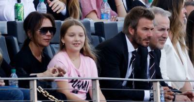 Harper Beckham shows her special bond with mum Victoria as she perches on her knee to watch dad David's team - www.ok.co.uk