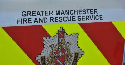 Firefighters tackle flames following crash on busy main road - www.manchestereveningnews.co.uk - Manchester