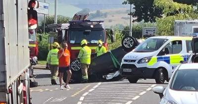 Car overturns on Scots road after hitting parked car as cops race to scene - www.dailyrecord.co.uk - Scotland