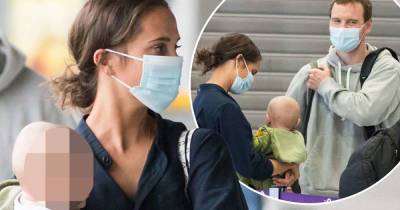 Alicia Vikander cradles baby while at airport with Michael Fassbender - www.msn.com - Sweden - Portugal - city Lisbon, Portugal
