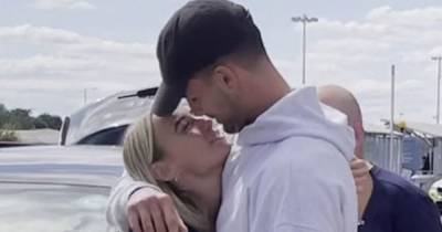 Love Island winners Millie and Liam share a kiss as they arrive back in the UK - www.manchestereveningnews.co.uk - Britain - county Love