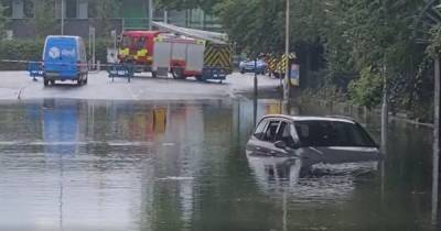Car left submerged after road floods in torrential rain - www.manchestereveningnews.co.uk - Britain - Manchester