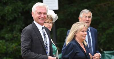 Phillip Schofield and wife Stephanie Lowe beam as they attend Ant McPartlin's wedding together - www.ok.co.uk