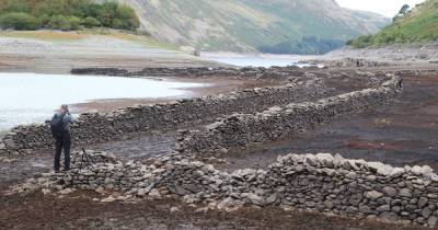 Incredible images show "lost village" reappear in Lake District reservoir - www.manchestereveningnews.co.uk - Manchester - Lake