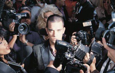 Robbie Williams announces 25th anniversary reissue of ‘Life Thru A Lens’ - www.nme.com