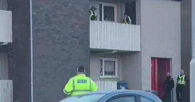 Police swoop on block of Scots flats as man taken to hospital after ‘assault’ - www.dailyrecord.co.uk - Scotland