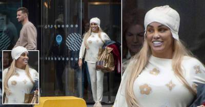 Katie Price is all smiles as she sports bandages in Liverpool after surgery - www.msn.com