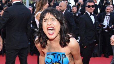 Topless, Screaming Protester Removed From Cannes Red Carpet (Photos) - thewrap.com