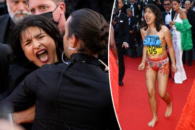 Topless, screaming woman crashes Cannes red carpet to protest war crimes - nypost.com - Ukraine - Russia
