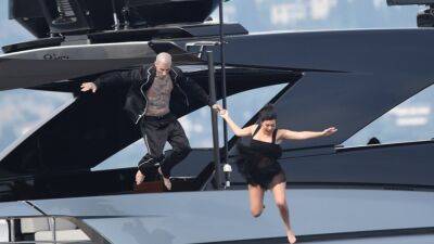 See Kourtney Kardashian and Travis Barker's Dramatic Leap From a Yacht After Their Italian Wedding - www.etonline.com - Italy