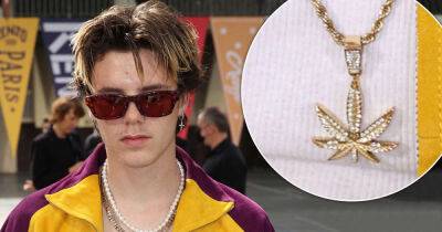 Cruz Beckham, 17, sports a gold cannabis necklace with a trendy jacket - www.msn.com