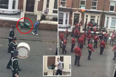 Man hurls garbage can at passing parade band in wild video: ‘Legendary’ - nypost.com - Britain - Ireland