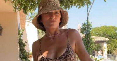 Davina McCall, 54, shows off washboard abs in leopard print bikini on holiday - www.ok.co.uk
