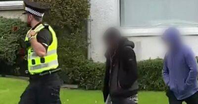 Angry mob gathers in Scots street chanting 'beast out' as police remove men from house - www.dailyrecord.co.uk - Scotland - city Renfrewshire - Beyond