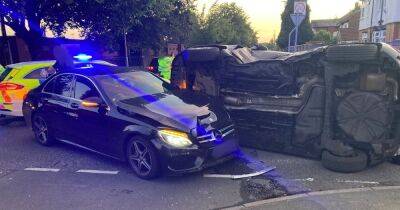 Car overturns in dramatic smash before cops stop TWO drivers filming scene on their phones - www.manchestereveningnews.co.uk - Manchester