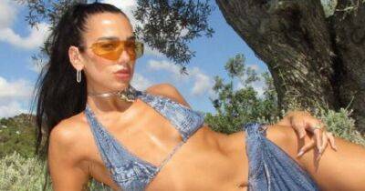 Dua Lipa channels the noughties as she celebrates her 27th birthday in double denim micro bikini and matching sarong - www.manchestereveningnews.co.uk - USA