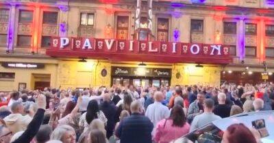 Rangers fans erupt into rousing song outside Glasgow theatre after show paused during fire drill - www.dailyrecord.co.uk - Scotland