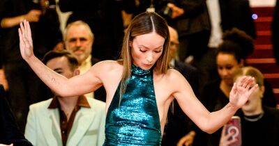 Olivia Wilde suffers wardrobe malfunction and almost falls as heel gets caught in gown - www.ok.co.uk - Spain