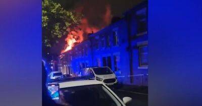 Dramatic moment fire tears through house as huge flames and smoke billow from roof - www.manchestereveningnews.co.uk - Manchester