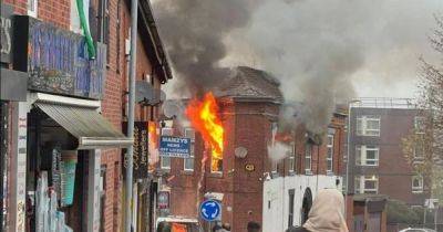 Dramatic scenes as woman taken to hospital after flames pictured pouring from flat windows - www.manchestereveningnews.co.uk - Manchester