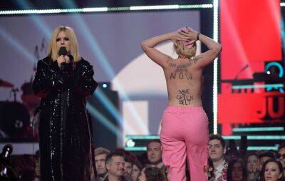 Avril Lavigne confronts topless protester onstage at Juno Awards - www.nme.com - Canada - county Ontario