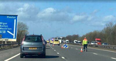 Coach with children on board crashes through motorway barrier after crash with car - www.manchestereveningnews.co.uk
