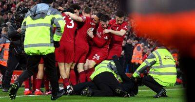 Teenager arrested after pitch invader collides with celebrating Liverpool players during 7-0 win over Manchester United - www.manchestereveningnews.co.uk - Manchester
