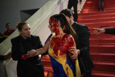 Cannes Red Carpet Protests Include Woman In Ukraine Dress Covered In Fake Blood, Anti-Surrogacy Group In Rare Show Of Defiance This Year - deadline.com - France - USA - Ukraine - Russia