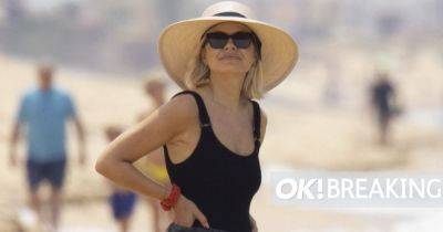 Holly Willoughby larks around on beach in black swimsuit amid Phillip Schofield scandal - www.ok.co.uk - Portugal