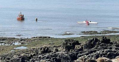Plane crashes into the sea in front of shocked beachgoers in Wales - www.dailyrecord.co.uk - Beyond