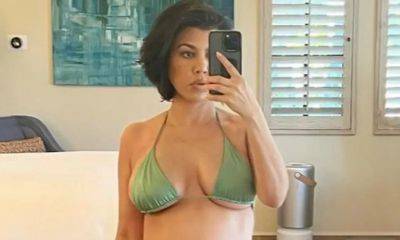 Kourtney Kardashian poses poolside showing off her baby bump - us.hola.com