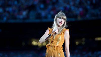 Taylor Swift Lets Out Epic Laugh While Performing Song Rumored to Be About Kanye West - www.etonline.com - state Washington - city Seattle, state Washington