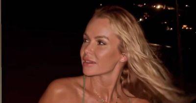 Amanda Holden appears ageless as she ditches bra on boat ride before 'breaking hearts' with bikini display - www.manchestereveningnews.co.uk - Britain - Italy