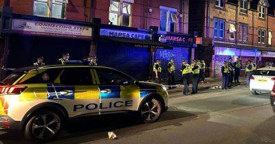 Police swarm street after 'disturbance' in Moss Side with two men hospitalised - www.manchestereveningnews.co.uk - Manchester