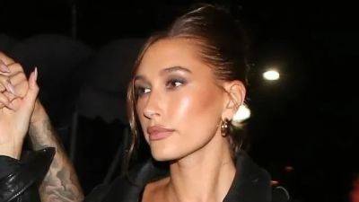 Hailey Bieber’s Answer to Power Dressing Is a Leather Bomber Jacket - www.glamour.com - Los Angeles - Italy - Adidas