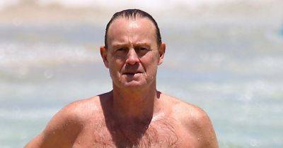 Jason Donovan, 55, looks years younger as he parades impressive physique in speedos on beach - www.ok.co.uk - Australia - Britain - Poland