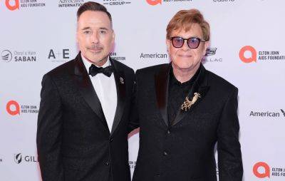 David Furnish shares Elton John health update ahead of upcoming surgery - www.nme.com
