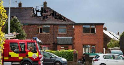 Fire investigation teams remain at scene of devastating house blaze that left a man dead and child fighting for life - www.manchestereveningnews.co.uk - Manchester