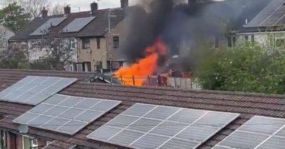 Dramatic footage shows fire burning at house in Stockport before emergency services swarm area - www.manchestereveningnews.co.uk - Manchester
